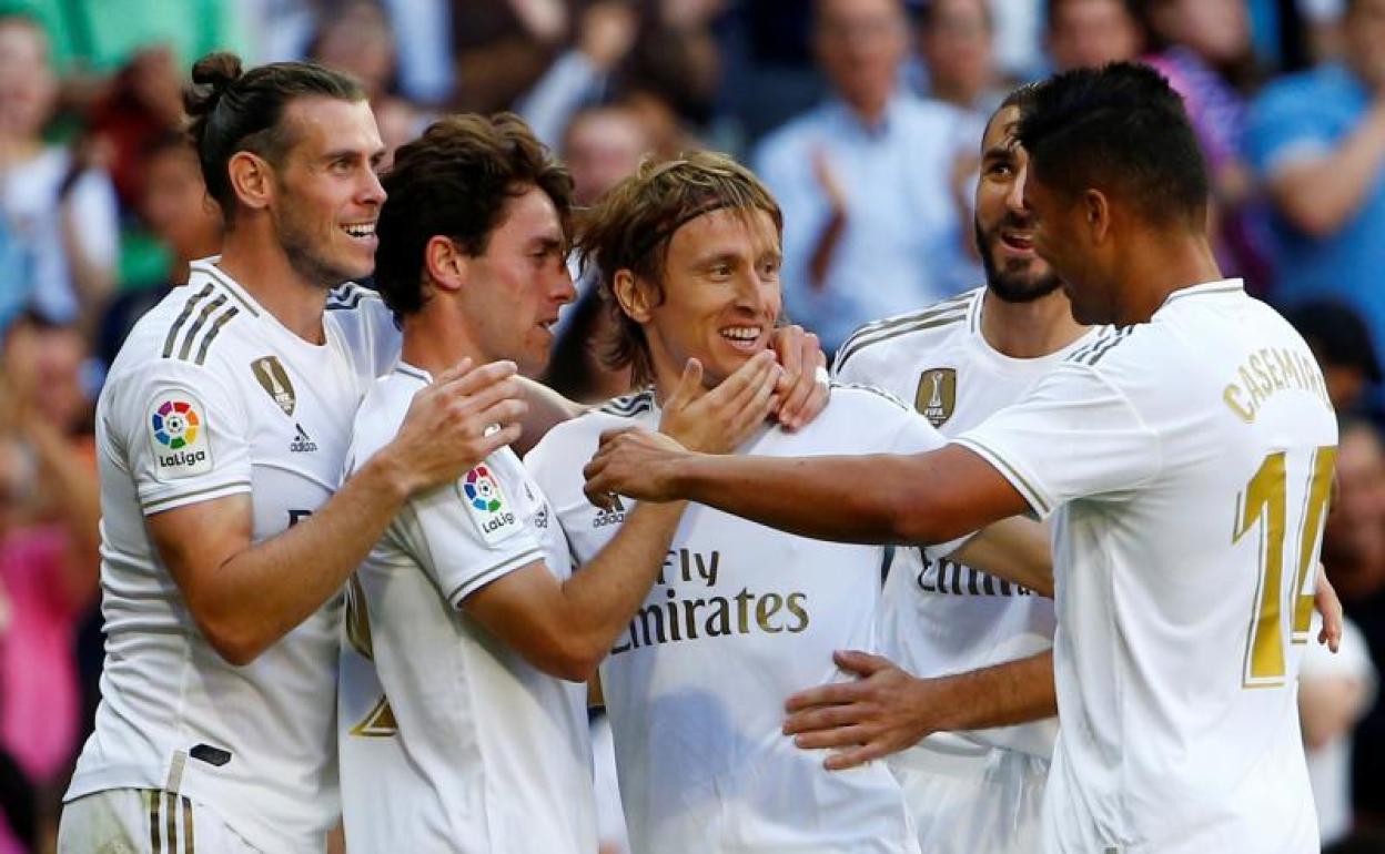 Luka Modric es abrazado por sus compañeros tras un gol de bandera. 