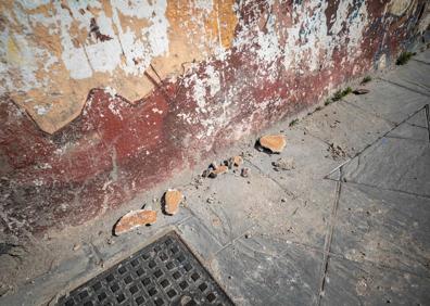 Imagen secundaria 1 - Los cascotes que ayer cayeron del muro de la Cuesta Escoriaza, y pantallazo de la denuncia presentada a través de la aplicación del Ayuntamiento 'Granada Mejora'.