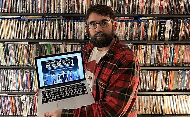 José Tito Martínez, con el ordenador en que vio por primera vez el guion de 'Parásitos', ahora con el cartel que certifica sus cuatro Oscar.