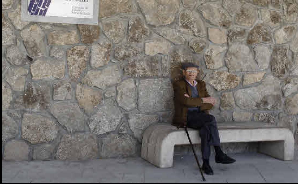 Un jubilado, sentado en un banco.