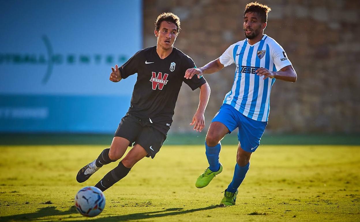 Luis Milla huye de la presión de Benkhemassa durante el partido. 