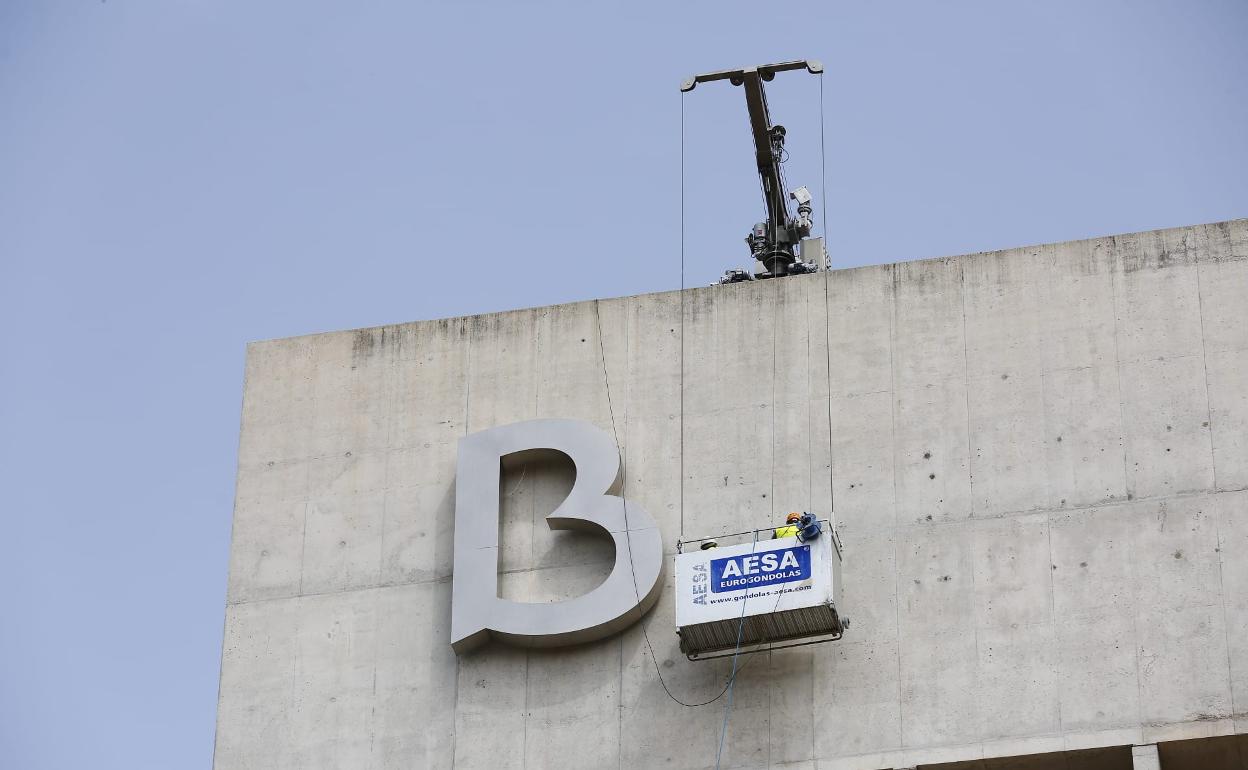 El icónico edificio, diseñado por Alberto Campo Baeza, ya porta el nuevo emblema bancario.