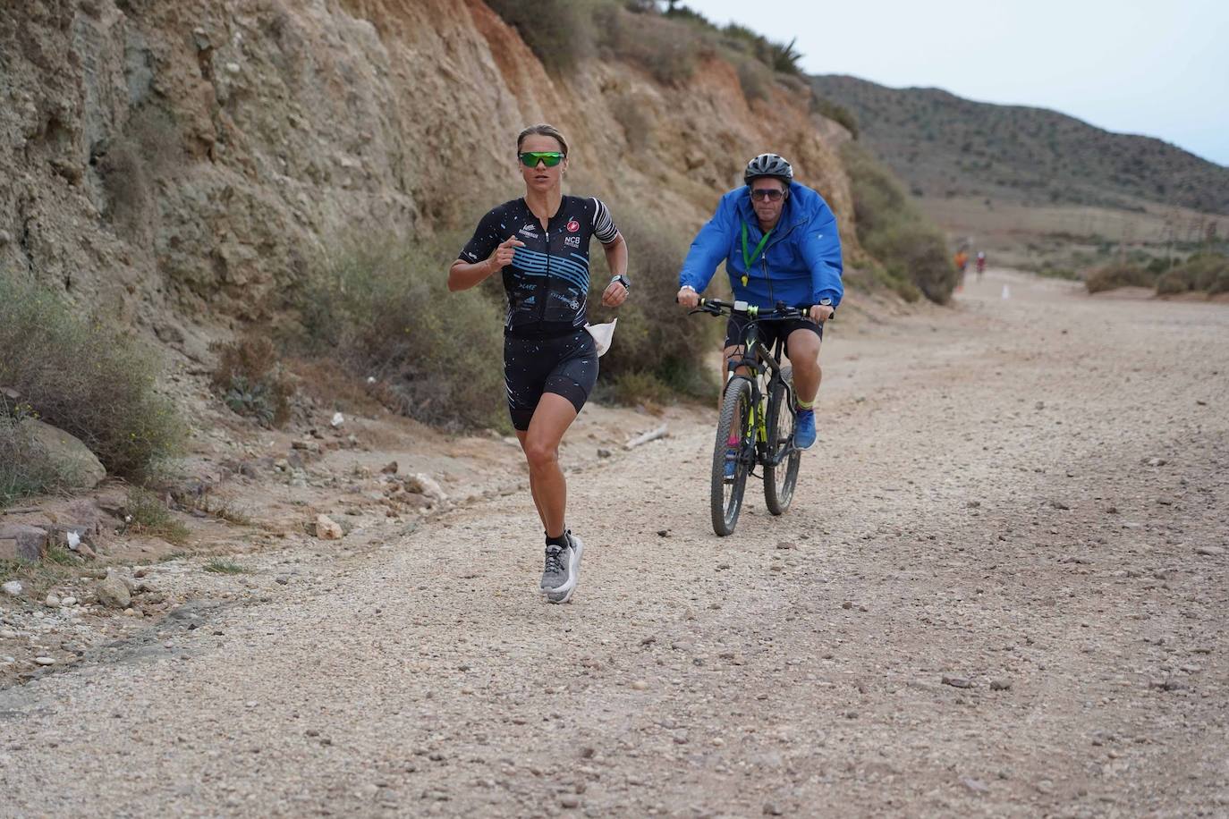 Imagen secundaria 1 - Arriba, el tramo de bicileta resultó clave, con 80 kilómetros en los que los triatletas se tuvieron que emplear a fondo. Abajo, los últimos kilómetros de carrera a pie se hicieron duros por el cansancio acumulado de una intensa jornada. .