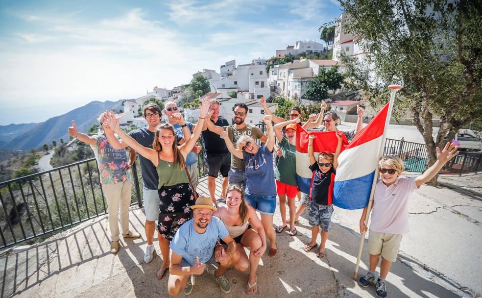 Turistas consultan una guía en casa de los ganadores del 'reality'