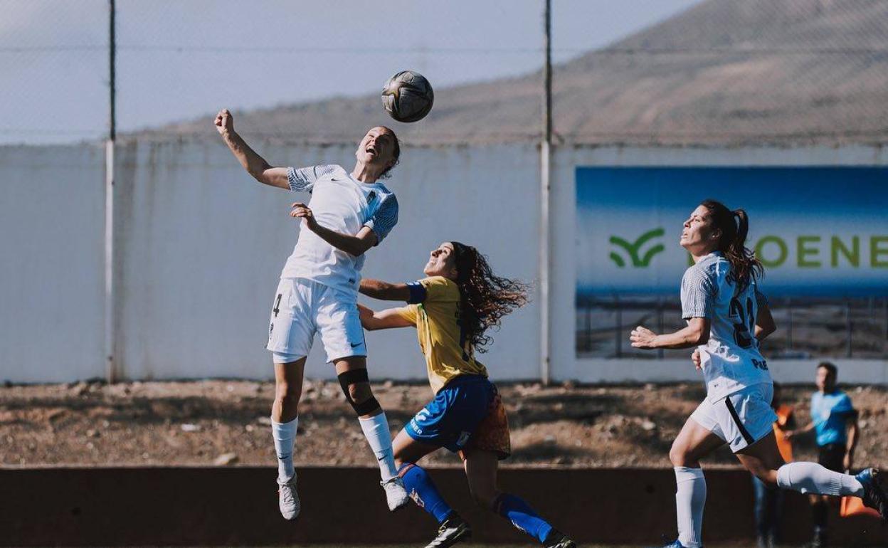 Moreno salta para despejar un envío aéreo ante el empujón de una canaria. 
