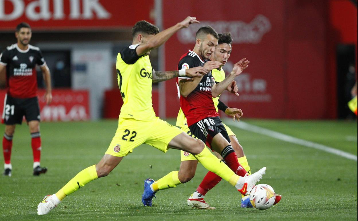 Santi Bueno intenta anticiparse a Iván Vicente en un Mirandés-Girona. 