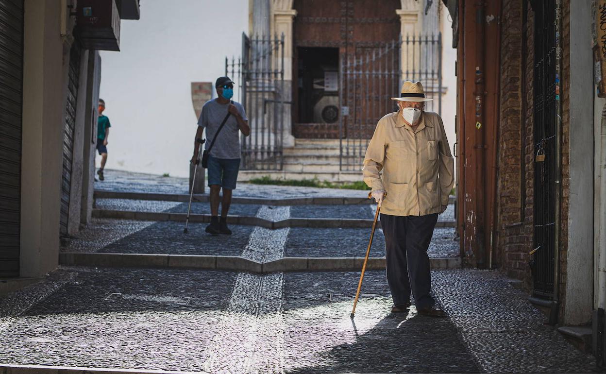 Un anciano pasea por el barrio del Albaicín.