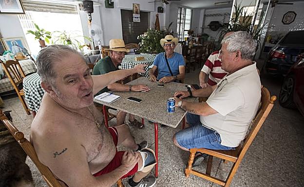 Manolo, con sus amigos, en la partida de dominó.