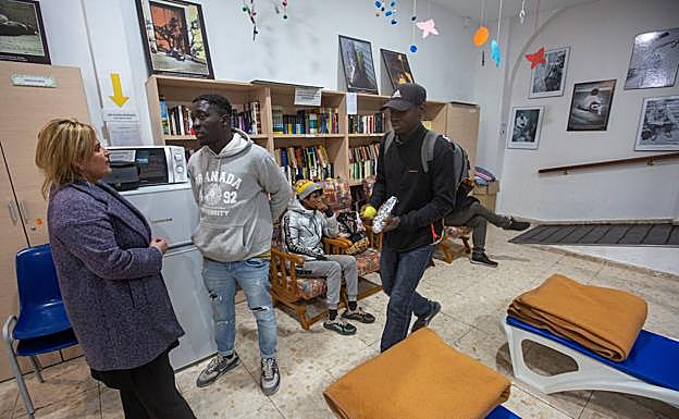 Imagen principal - La concejala de Derechos Sociales conversa en el refugio con los usuarios. 