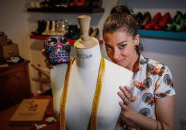 Carmencita Calavera, junto a uno de sus maniquíes en el taller de costura de su casa.