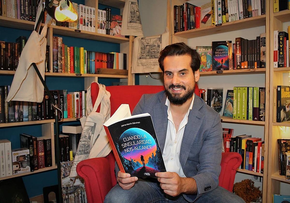 Jaime Martín, en la librería El tiempo perdido, con un ejemplar de su novela 'Cuando la singularidad nos alcance'.
