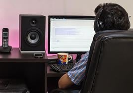 Imagen de archivo de un joven trabajando con su ordenador.