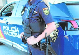 Una agente de la Policía Nacional ante un vehículo del CNP.