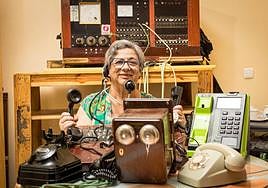 María Alicia posa con algunos de los teléfonos que conserva de la época en la que su casa se convirtió en la centralita de Dílar.