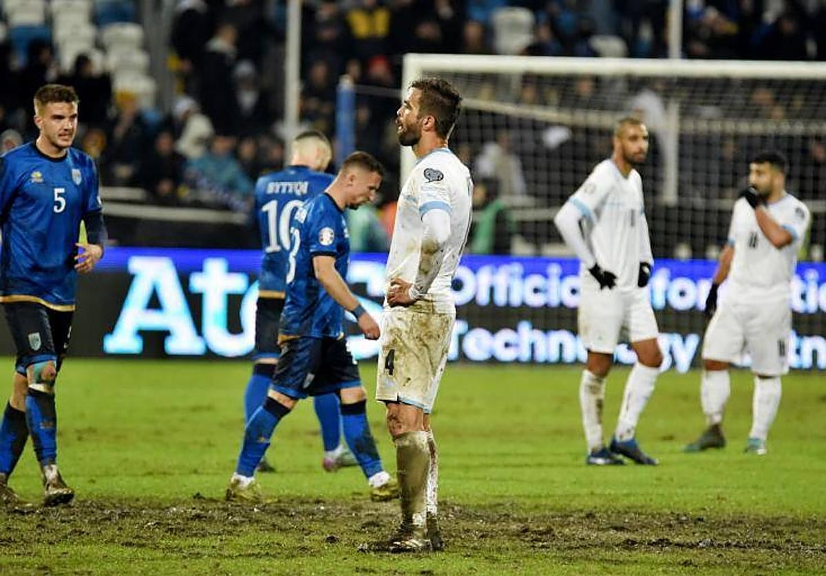 Futbolistas de Israel, preocupados tras la derrota en Kosovo sobre el barrizal.