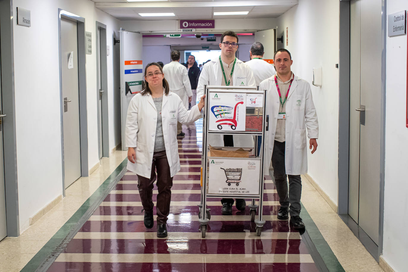 Eva, Alberto y Óscar, durante el reparto de libros por los pasillos del hospital.
