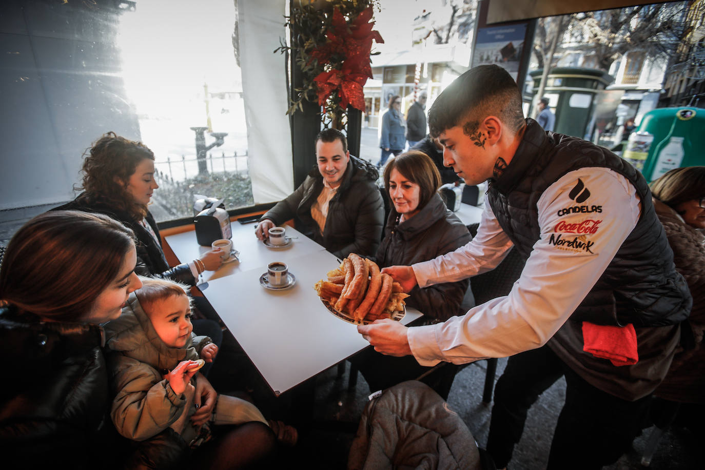 Sirviendo una bandeja de churros recién hechos en la cafetería Alhambra, situada en la plaza BibRambla.