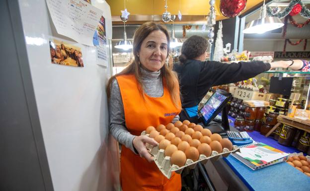 Imagen principal - María ÁNgeles vende huevos y aceite, rebajados tras las medidas. Maribel muestra sus quesos, que también bajan de precio porque la leche es alimento básico. Las frutas y verduras también han bajado de precio.