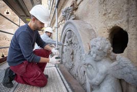 Restauradores trabajando en el Pilar de Carlos V, cuyas obras terminarán para el mes de marzo.