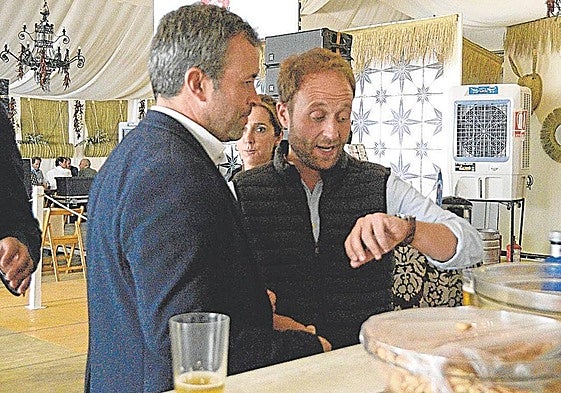 Julio Millán (PSOE) y Erik Domínguez (PP) comparten miran en reloj, en una Feria de San Lucas.