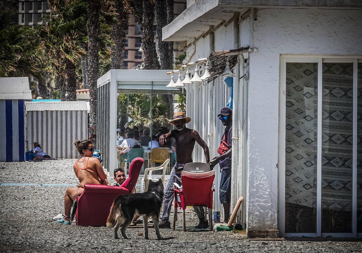 Imagen principal - Tertulia en la terraza del chiringuito Calabré, interior del chiringuito y Serge con un amigo en la playa de San Cristóbal.