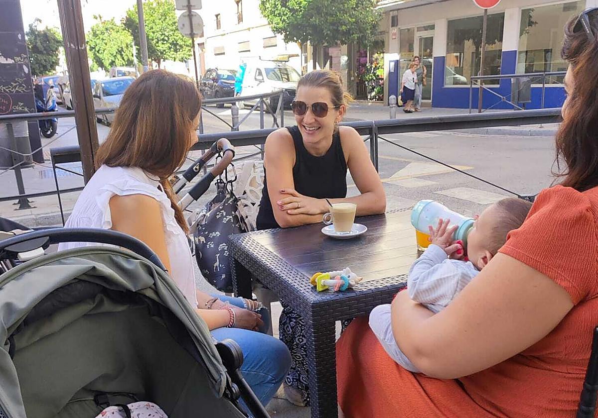 Varias clientas junto a sus bebés en la terraza de la cafetería.