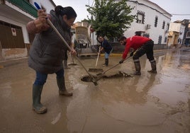 Vecinos afectados ayudan a desaguar las calles en Chauchina.