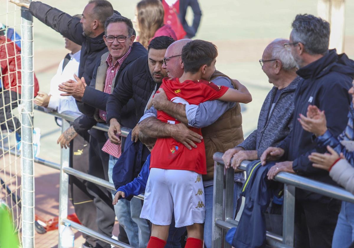 Un alevín del Arenas celebra un gol con su familia.