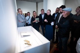 El artista, a la izquierda, muestra una de las piezas a Laura García Lorca y representantes institucionales.