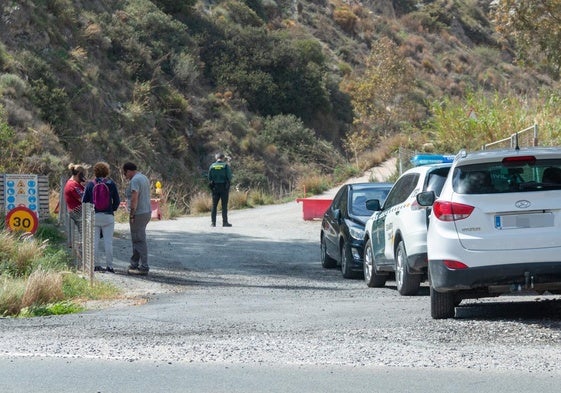 Vehiculos policiales, en el acceso al cortijo en el que ocurrió el doble crimen.