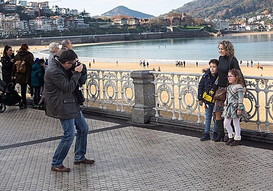 Turistas se hacen fotos en el Paseo de la Concha de San Sebastián.