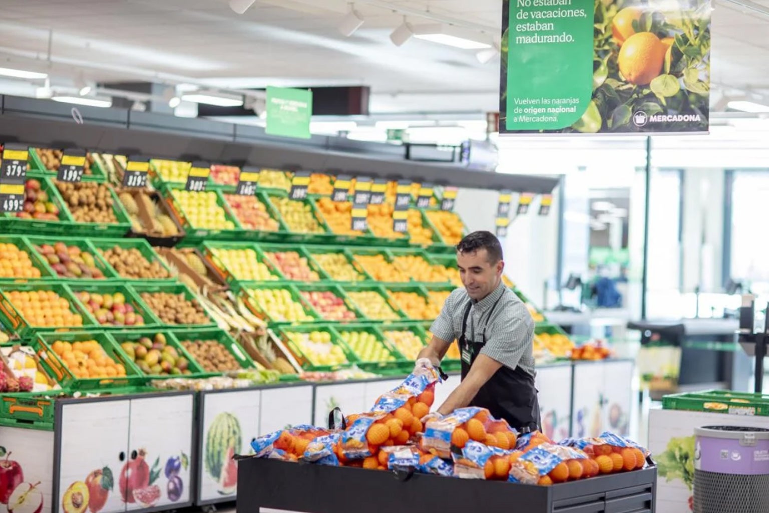 Un trabajador de Mercadona en la seccion de frutas.