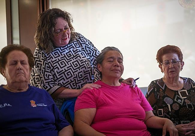 La psicóloga, junto a Antonia, en el taller de memoria.