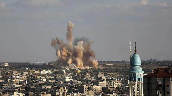 Una columna de humo se desprende de un edificio tras un ataque israelí. 