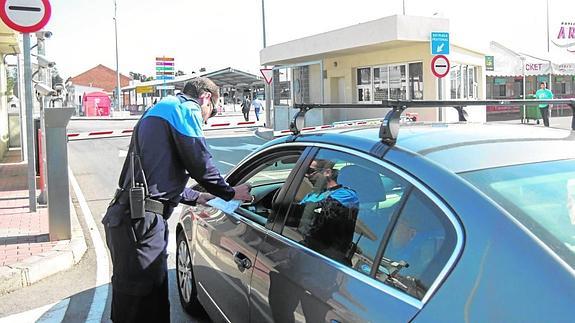 Un efectivo de la Policía Portuaria realiza la inspección de un vehículo a la entrada de las instalaciones de Motril.