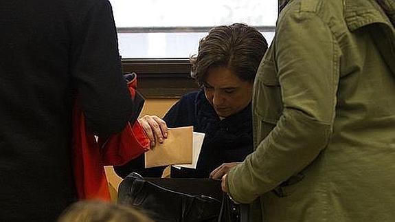 Ada Colau busca en su bolso el DNI, que se había dejado en casa.