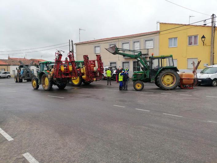 Los agricultores, con mascarillas y guantes, en el punto de encuentro para iniciar la desinfección.