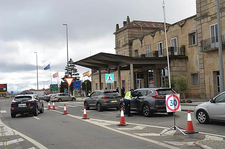 Un policía examina, en un control, el salvoconducto de un turismo que entra en Fuentes de Oñoro.