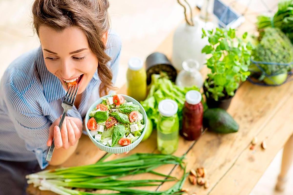 Una mujer comiendo una ensalada