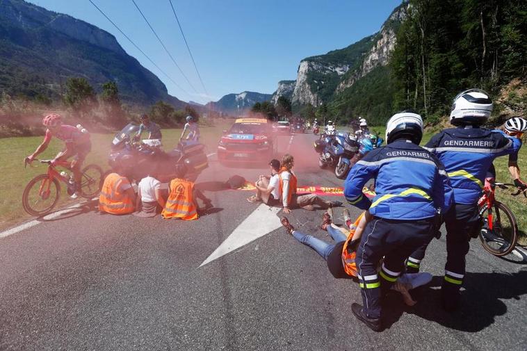 Unos manifestantes con bengalas y encadenados paran el Tour de Francia en medio de la etapa
