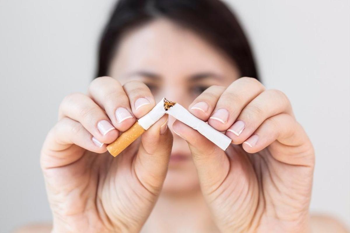 Una mujer rompe un cigarro