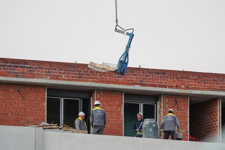 Obreros trabajando en la construcción de un edificio de viviendas