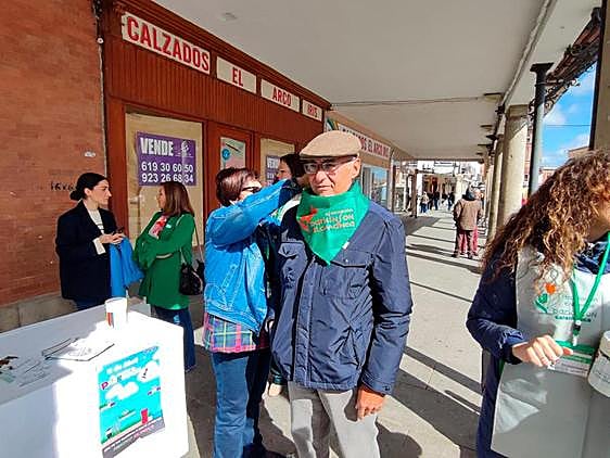 Teresa Martín, presidenta de Parkinson Salamanca, pone el pañuelo de la asociación a Vicente González.