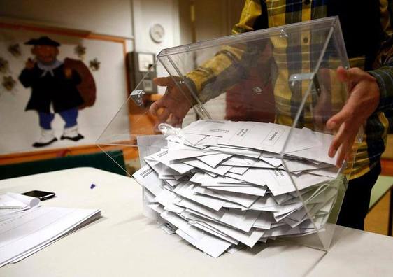 Un miembro de una mesa electoral procede al recuento de votos.