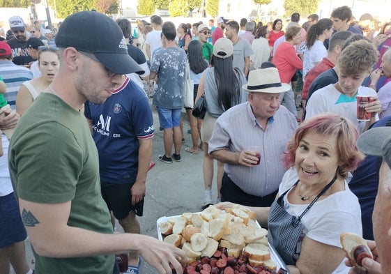 Momento del reparto de las raciones de chorizo y pan en la chorizada celebrada en Fuentes de Béjar