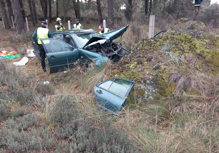 Imagen principal - Coche destrozado tras el impacto contra la roca