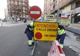 Los trabajadores de la empresa retiran el cartel que cortaba el paso.