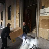 Dos operarios trasladando documentos del Palacio de Justicia.