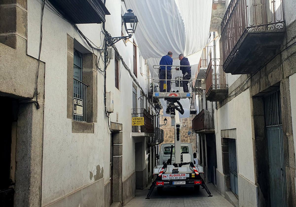 Imagen de la colocación de los primeros adornos con motivo del Corpus Cristi, en la calle Las Armas de Béjar.