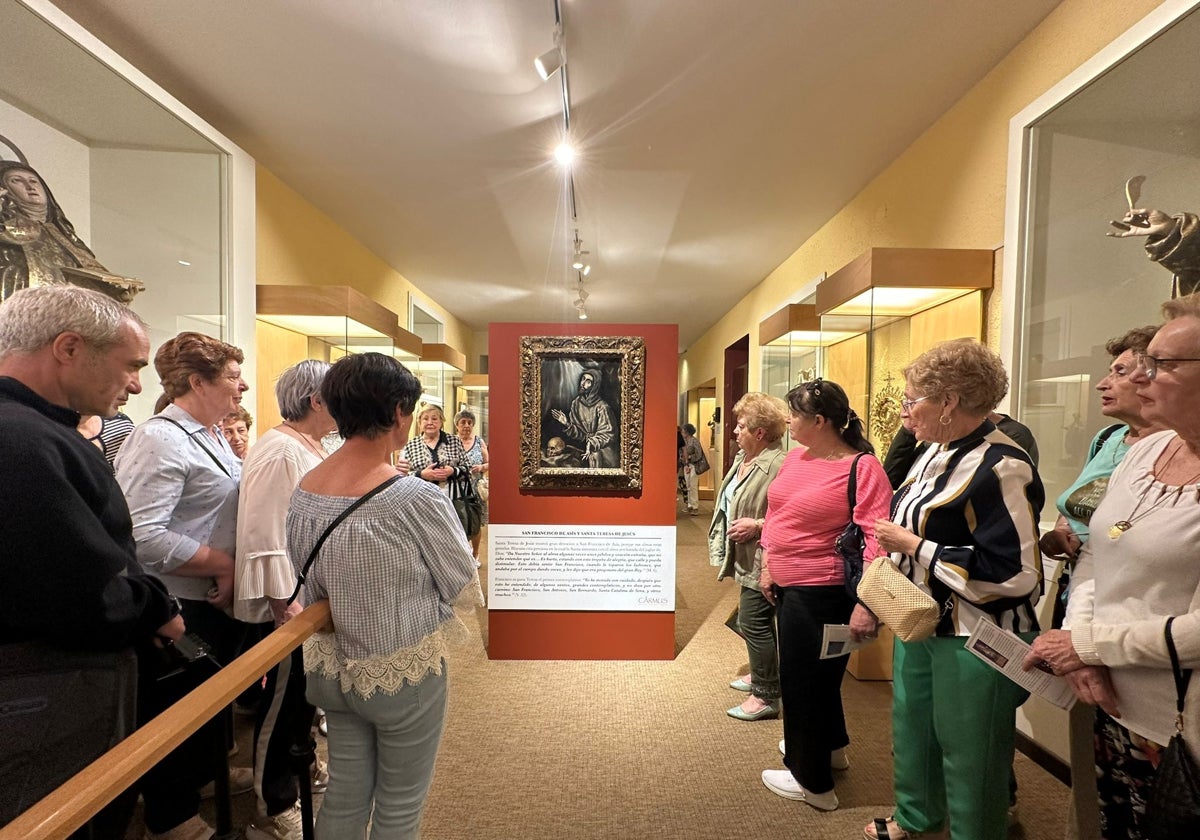 Visitantes viendo el cuadro de El Greco en la exposición De Claris Mulieribus de Alba de Tormes.